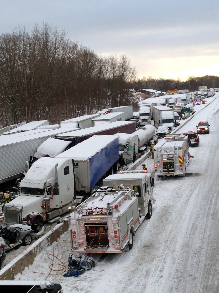 Emergency crews work at the scene of a massive pileup involving more than 40 vehicles, many of them semitrailers, along Interstate 94 in Indiana. AP Photo