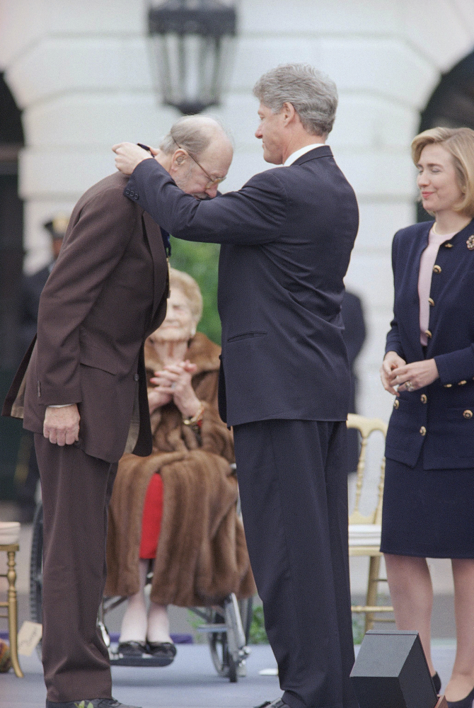 This Oct. 14, 1994, file photo shows President Clinton presenting folk musician Pete Seeger with a 1994 National Medal of Arts, in Washington at the White House. The American troubadour, folk singer and activist Seeger died Monday Jan. 27, 2014, at age 94.