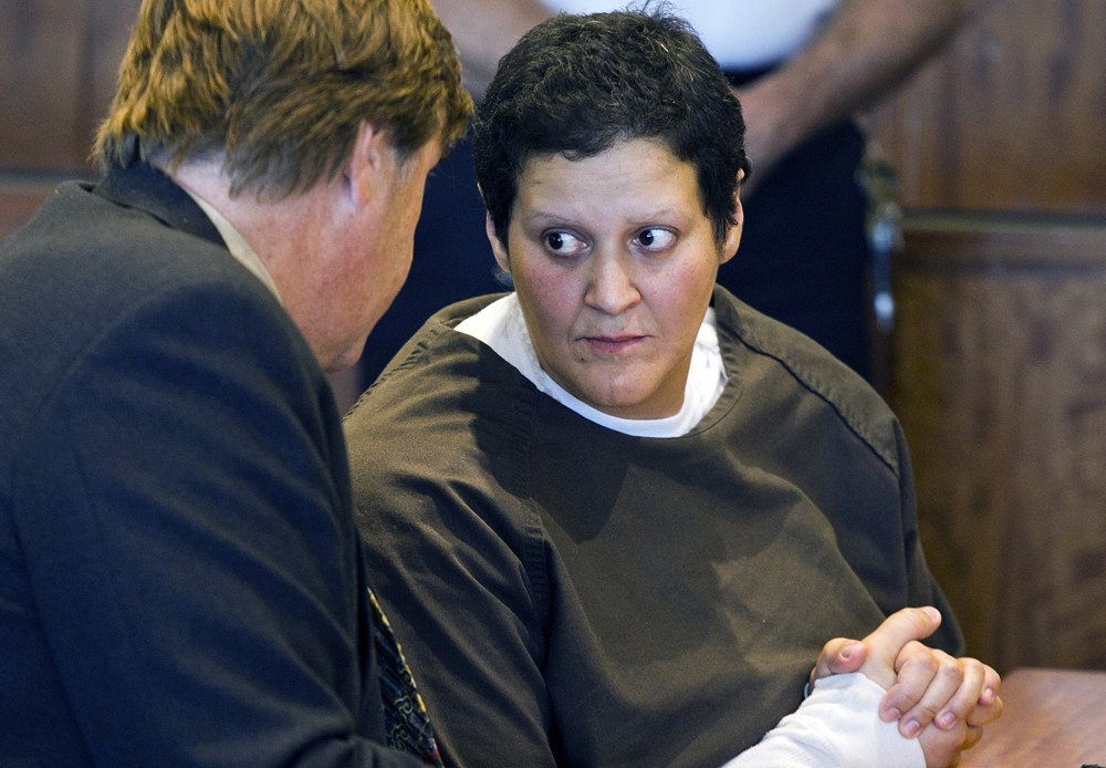 In this Oct. 24, 2013, photo, Tanya Singleton, cousin of former New England Patriots football player Aaron Hernandez, speaks with defense attorney Peter Parker during a bail hearing at Superior Court in Fall River, Mass.