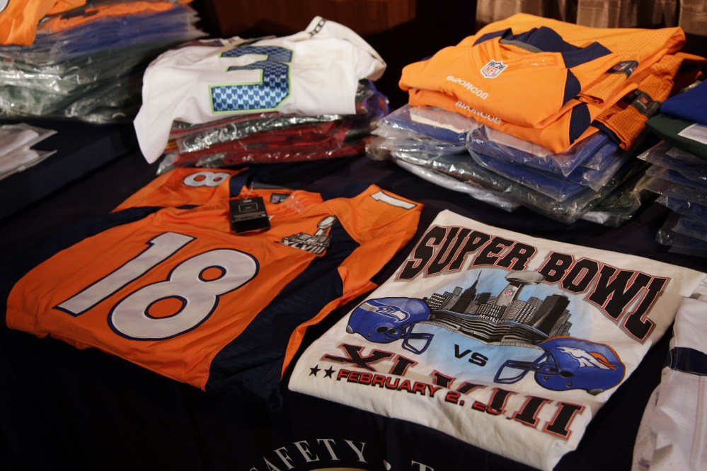 Seized counterfeit NFL merchandise is displayed before a news conference at the NFL Super Bowl XLVIII media center on Thursday in New York.
