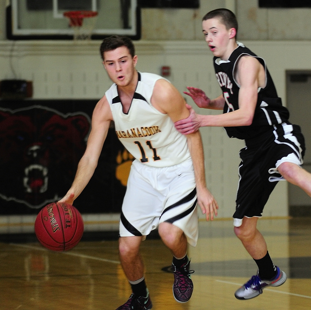 Staff photo by Joe Phelan Maranacook senior guard Taylor Wilbur, left, tries to get past Gardiner junior guard Alex LaPointe during a game on Friday January 31, 2014 in the Mr. Burbank Memorial Gym in Readfield.