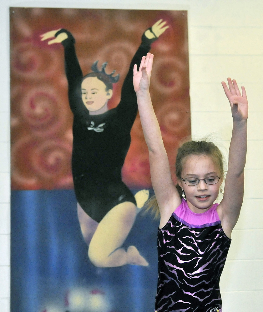 Handy exercise: Courtney Hogan, 10, practices the balance beam at Decal Gymnastics in Farmington on Saturday. Decal re-opened today after closing because of flooding.