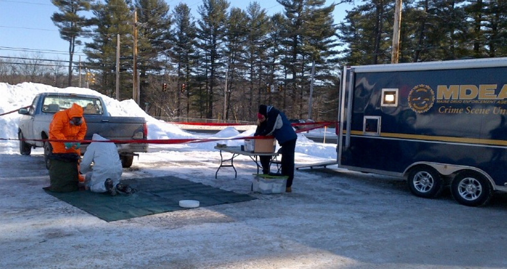 Maine Drug Enforcement agents gather evidence, believed to indicate a methamphetamine lab, from a pickup truck parked along Route 26 in Oxford on Friday morning. They also searched a nearby mobile home at 209 Webber Brook Road in Oxford and continued to gather evidence at two other locations in remote Mason Township and in Gilead.