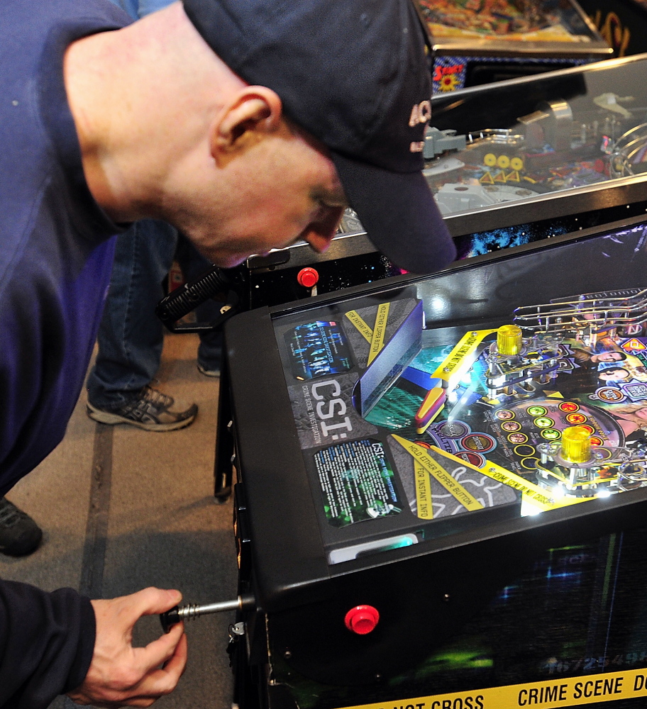 Jerry Lindsay of Oakland sets the plunger to shoot his ball into the game at the Maine State Pinball Championship in Gorham on Saturday.
