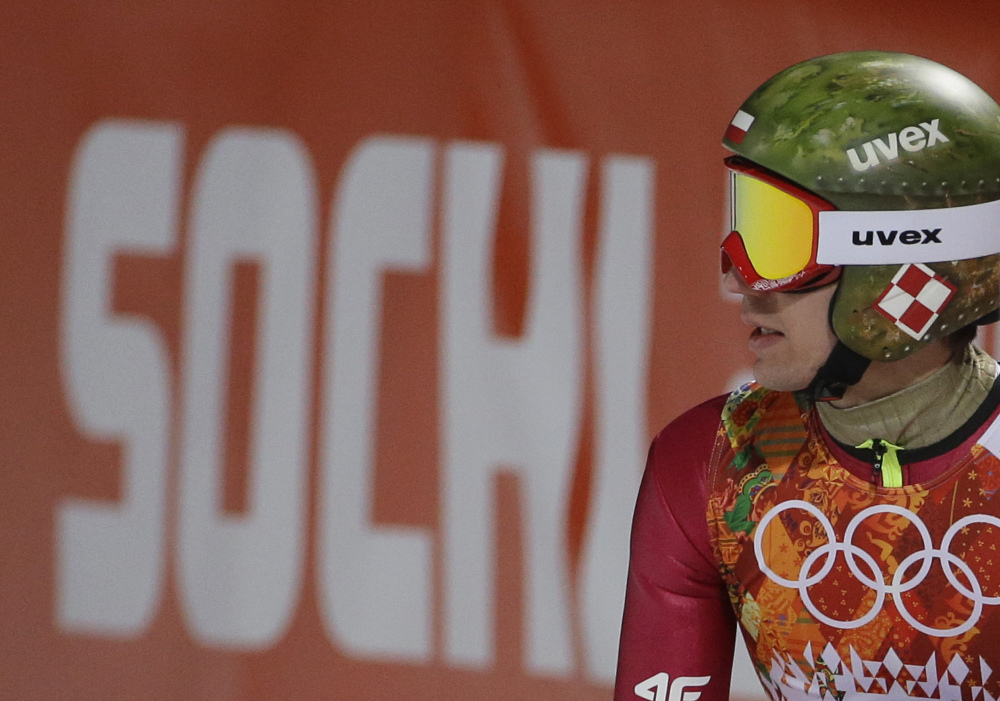 Poland’s Kamil Stoch checks the scoreboard after an attempt during the men’s normal hill ski jumping qualification at the 2014 Winter Olympics on Saturday in Krasnaya Polyana, Russia.