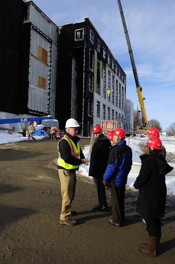 Courthouse progress: Phil Johnston, a project manager, wearing a white helmet, leads a tour for the Legislature’s Judiciary Committee on Thursday at the new court building in Augusta.