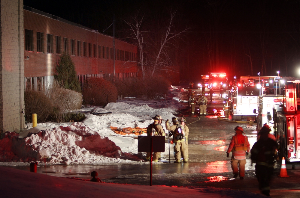 Emergency crews from several towns work outside the New Hampshire Ball Bearings Inc. plant after an explosion Monday in Peterborough, N.H.