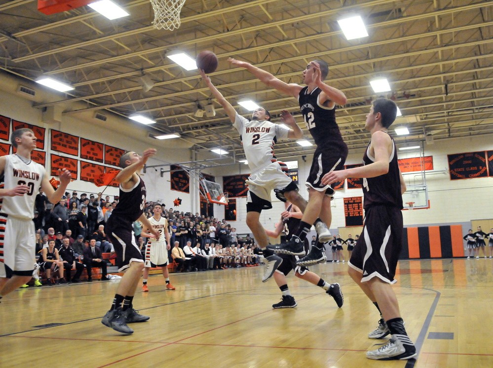 Staff photo by Michael G. Seamans HIGH SCHOOL BASKETBALL: Winslow High School's Nason Lanphier, 2, drives to the basket as Foxcroft Academy's Kolby Kendall, 42, tries to defend in Winslow on Wednesday.