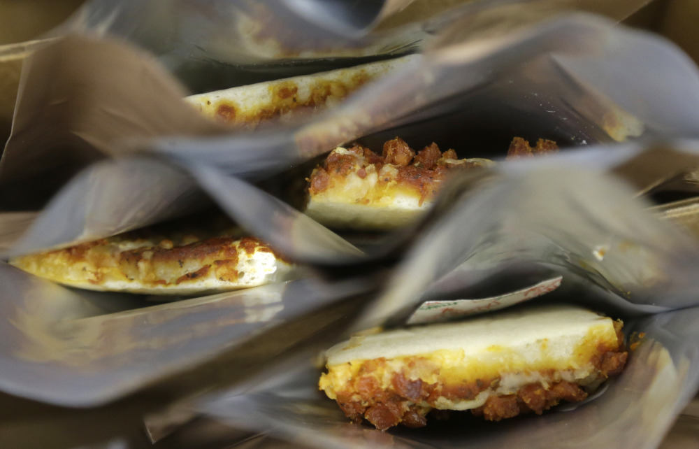 Prototype pizza slices in MRE packets: Scientists have tweaked the acidity of the sauce, cheese and dough to make it harder for oxygen and bacteria to thrive.