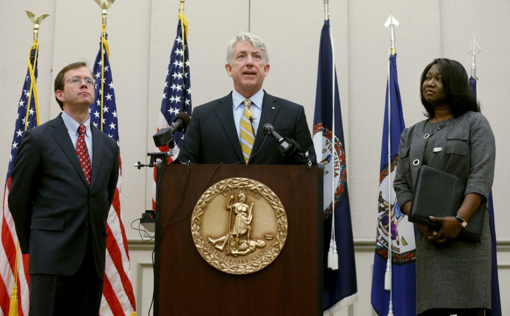 Virginia Attorney General Mark Herring, center, flanked by Solicitor General Stuart Raphael, left, and Chief Deputy Attorney General Cynthia Hudson, right, speaks Friday during a news conference in which he applauded the overnight decision by a federal judge to strike down Virginia’s ban on gay marriage.
