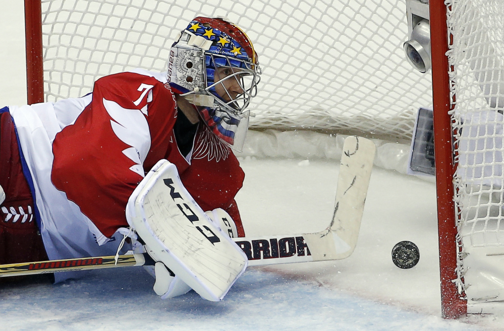 Russia goaltender Sergei Bobrovski watches the puck bounce back off the net after a goal by the USA in the second period of a men’s hockey game at the 2014 Winter Olympics on Saturday.