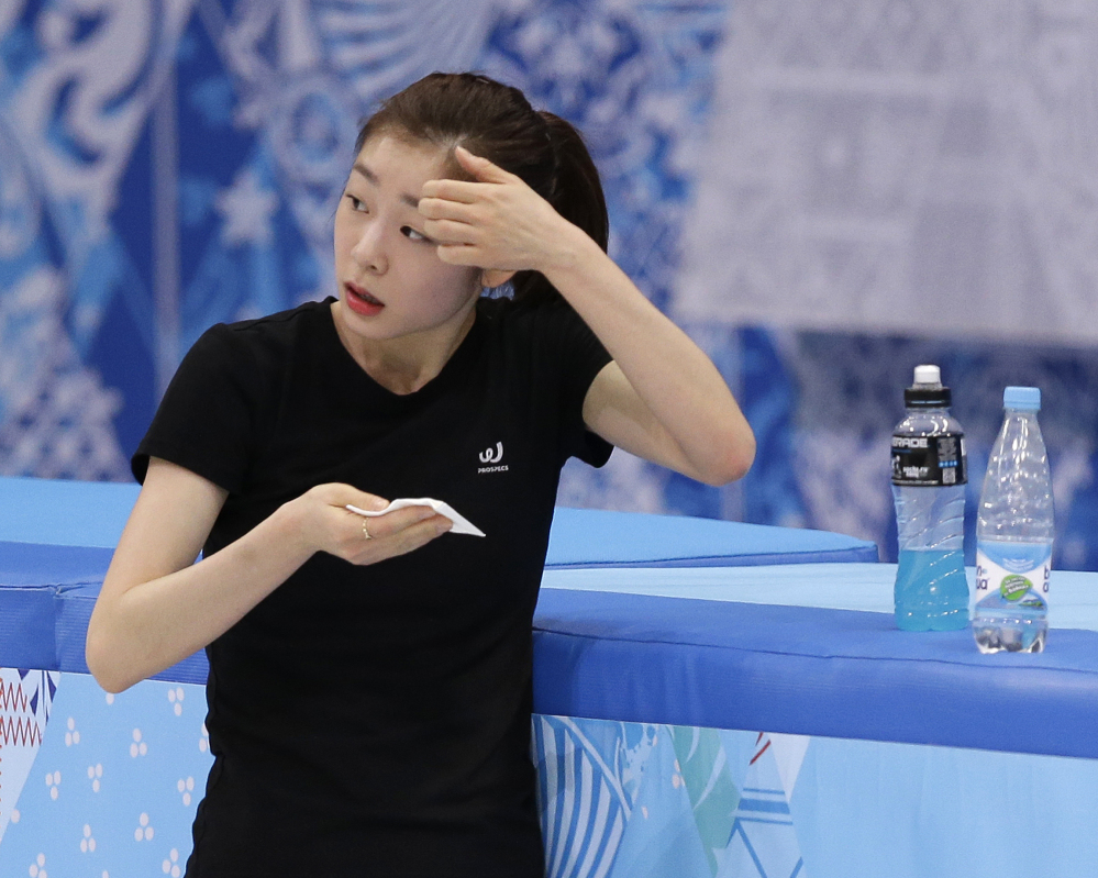 Yuna Kim of South Korea wipes her face during a practice session at the Iceberg Skating Palace during the 2014 Winter Olympics Sunday.