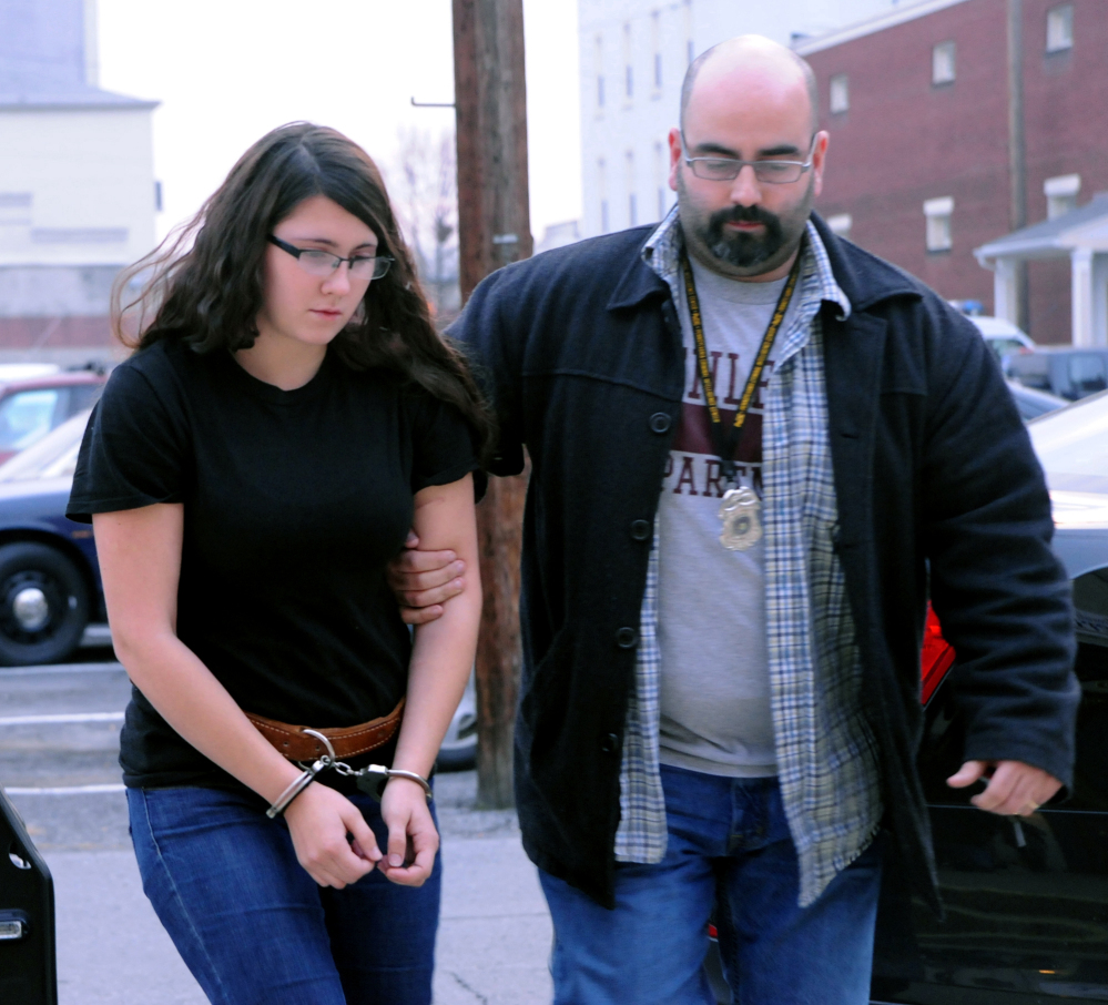 Miranda K. Barbour is led into District Judge Ben Apfelbaum’s office in Sunbury, Pa., by Sunbury policeman Travis Bremigen in December.
