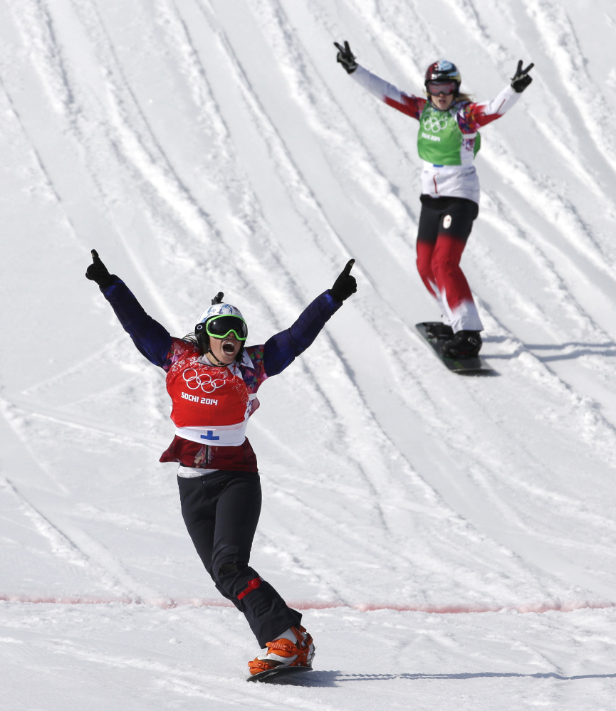 Czech Republic’s Eva Samkova celebrates after taking the gold medal in the women’s snowboard cross final, ahead of silver medalist Dominique Maltais of Canada, right, at the Rosa Khutor Extreme Park, at the 2014 Winter Olympics Sunday.
