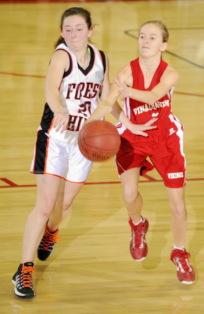KNOCK IT OFF: Forest Hills junior guard Keely Taylor, left, knocks ball away from Vinalhaven sophomore guard Hannah Noyes during a Western Class D tournament game Tuesday 4 at the Augusta Civic Center. The Tigers won 70-27.