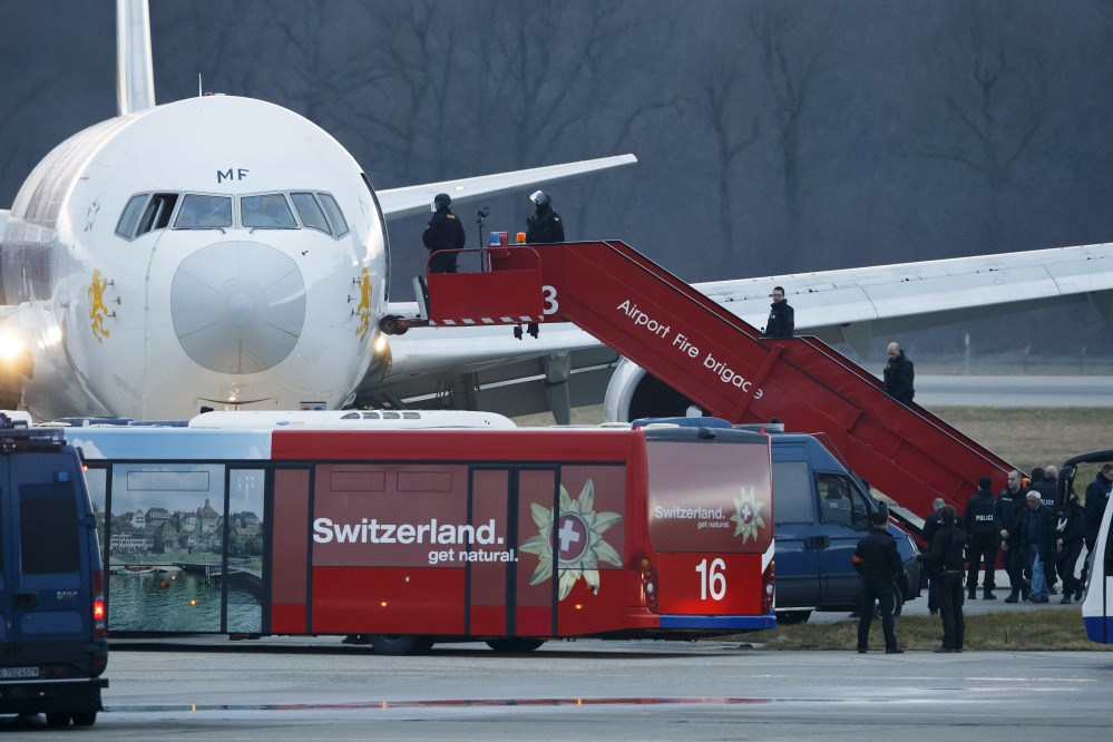 Police board a hijacked Ethiopian Airlines plane in Geneva, Switzerland, Monday. After he was arrested by Swiss authorities, the pilot said he felt “threatened” in Ethiopia, police said but did not specify why or by whom he claimed to feel threatened.