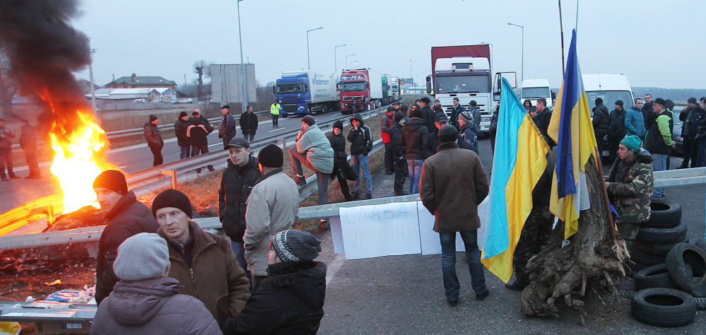 Ukrainian truck drivers burn tires as they block the highway leading to the border with Poland near the crossing point in Krakovets, Ukraine, Wednesday. The drivers set the blockade to support anti-government protest in the coutry’s capital Kiev and other cities.