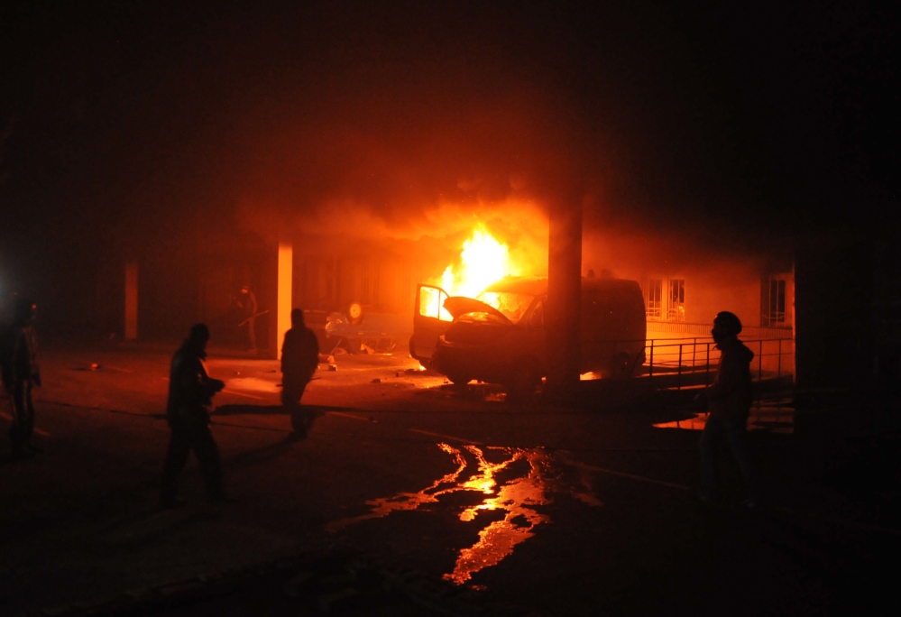 Ukrainian protesters burn a car outside a Security Service headquarters in Lviv, western Ukraine, early Wednesday. The violence on Tuesday was the worst in nearly three months in a nation divided in loyalties between Russia and the West.