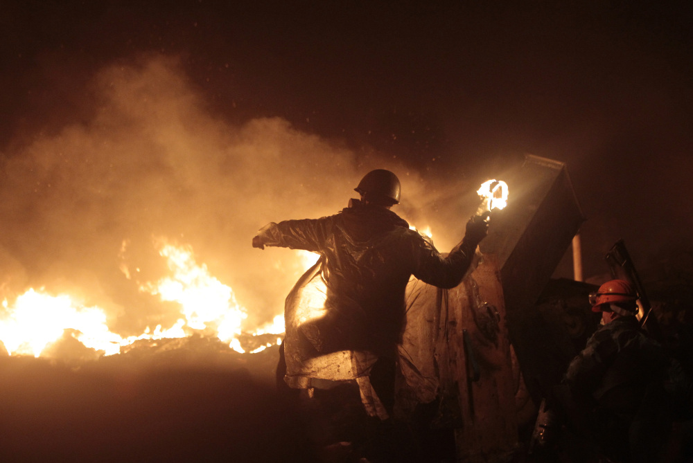 Anti-government protesters clash with riot police in Kiev’s Independence Square, the epicenter of the country’s current unrest, in Ukraine, Thursday.