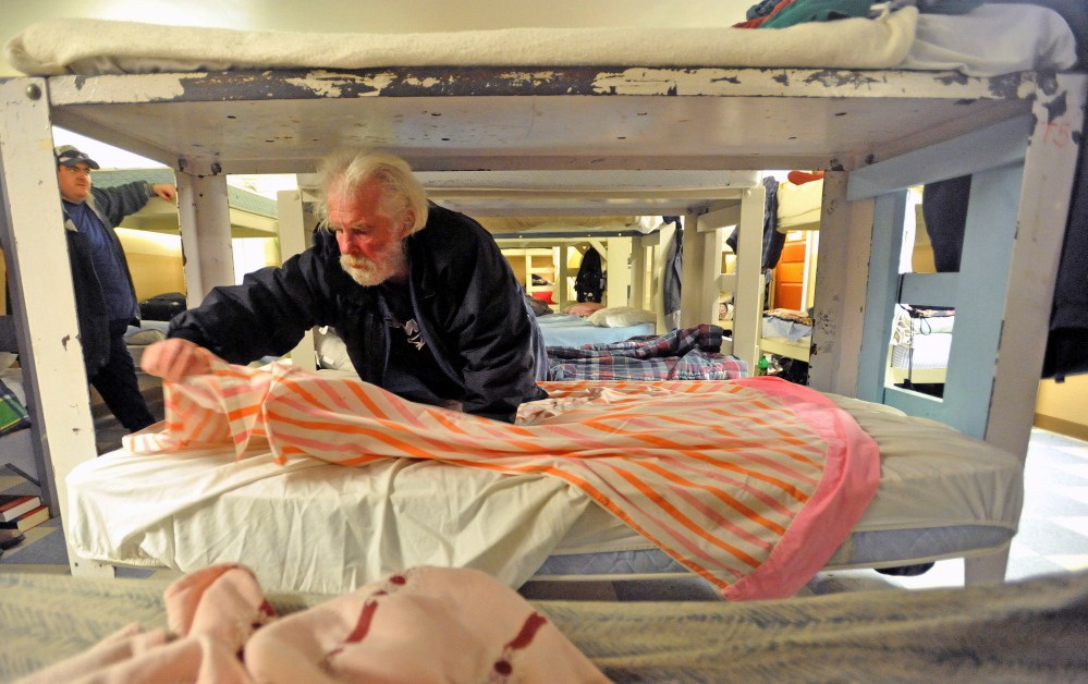 SHELTER: Edward Myshralo, 55, of Presque Isle, settles in for his first night Thursday at the men’s shelter at Trinity Evangelical Free Church in Skowhegan.