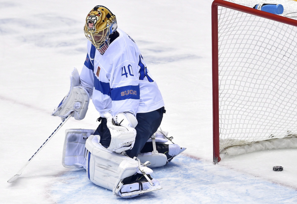 A shot by Canada defenseman Drew Doughty gets by Finland goalie Tuukka Rask (40) for the winning goal during overtime in a men’s ice hockey game at the Winter Olympics Sunday, Feb. 16.