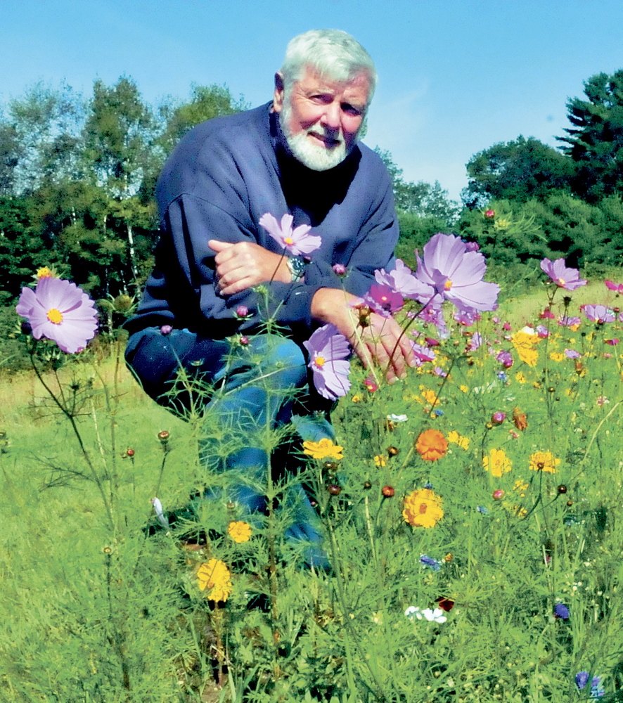 DEPARTMENT HEAD RAISES: Oakland Transfer Station Manager John Thomas beside flower gardens he planted at the Oakland Transfer Station. Thomas’ position is one of eight in town that could see a pay raise if a proposed budget is passed that includes wage increases for the employees that are currently paid at levels below other towns of similar size.