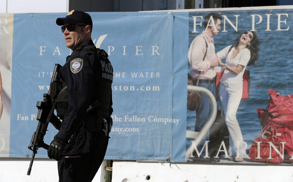 Heavily armed Homeland Security police patrol outside the Moakley Federal Court House in Boston after the building was evacuated two days after last year’s Boston Marathon bombing. Security has been stepped up for this year’s race on April 21.