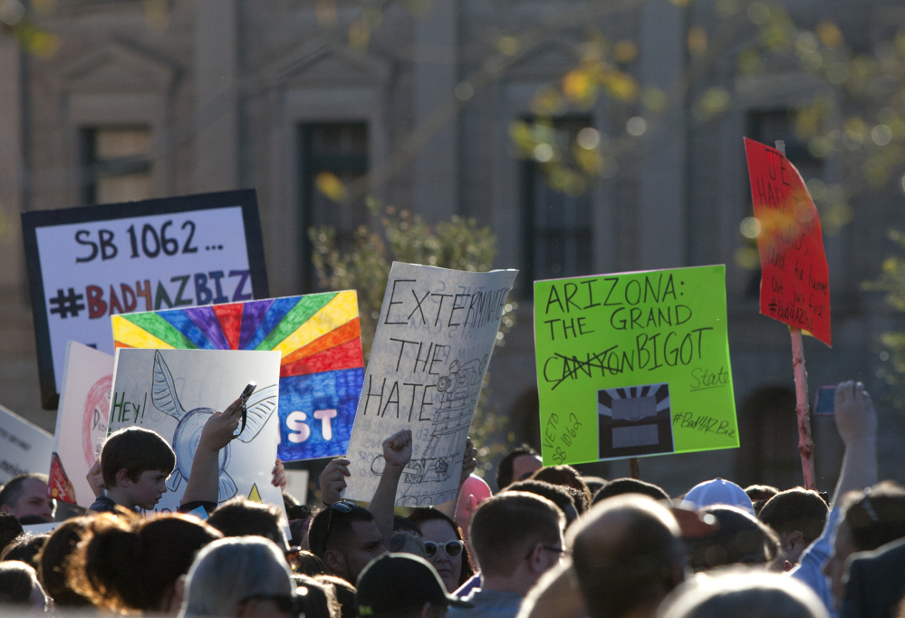 Opponents of the SB1062, a religious freedom bill, urged Gov. Brewer to veto the bill during a protest rally at the state Capitol, Friday, Feb. 21, 2014.