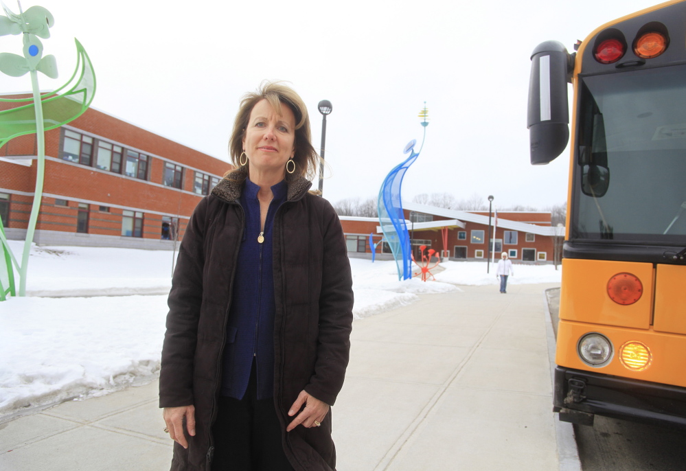 Cathy Steele, PTO president and parent of students at Ocean Elementary School in Portland, stands outside the school which is next to an apartment at 144 Ocean Ave. where one person was arrested in a crack raid on Wednesday.