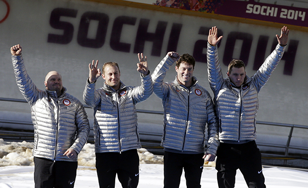 The team from the United States USA-1, with Steven Holcomb, Curtis Tomasevicz, Steven Langton and Christopher Fogt, celebrate after they won the bronze medals in the men's four-man bobsled competition final at the 2014 Winter Olympics, Sunday, Feb. 23, 2014, in Krasnaya Polyana, Russia.(AP Photo/Dita Alangkara)