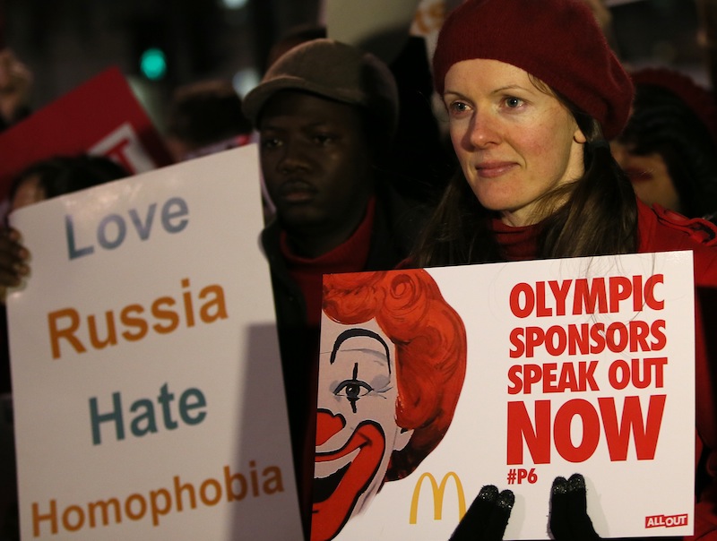 Lesbian and Gay Rights activists take part in a demonstration aimed to coincide with the upcoming Winter Olympics in Sochi, Russia, against laws aimed at stifling Gay Rights in Russia, opposite Downing Street in London, Wednesday, Feb. 5, 2014. In London, about 150 people rallying outside Prime Minister David Cameron's office in London urged McDonald's and the IOC's other sponsors to speak out. The activists there said they plan to deliver a petition signed by more than 100,000 people to a nearby McDonald's restaurant.