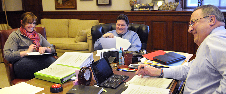 Gov. Paul LePage works on his third State of the State address Monday with his daughter, Lauren LePage, and Chief of Staff John McGough in the governor's office in Augusta. The governor will present the speech Tuesday during a joint session of the Legislature. Lauren LePage serves as an adviser on the governor's re-election campaign.