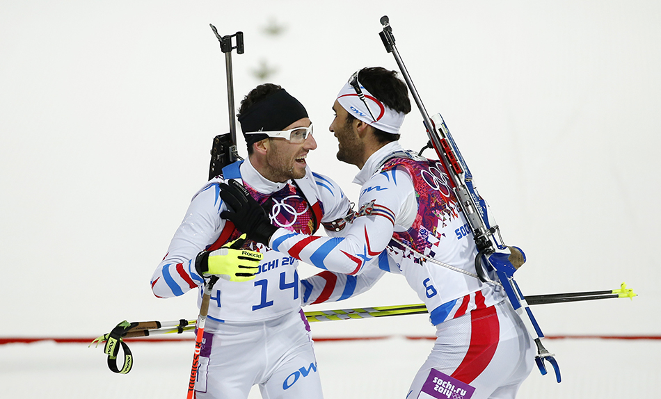 France's gold medal winner Martin Fourcade, right, hugs his teammate bronze medal winner Jean Guillaume Beatrix after the men's biathlon 12.5k pursuit, at the 2014 Winter Olympics, Monday, Feb. 10, 2014, in Krasnaya Polyana, Russia. (AP Photo/Felipe Dana) 2014 Sochi Olympic Games;Winter Olympic games;Olympic games;Spor