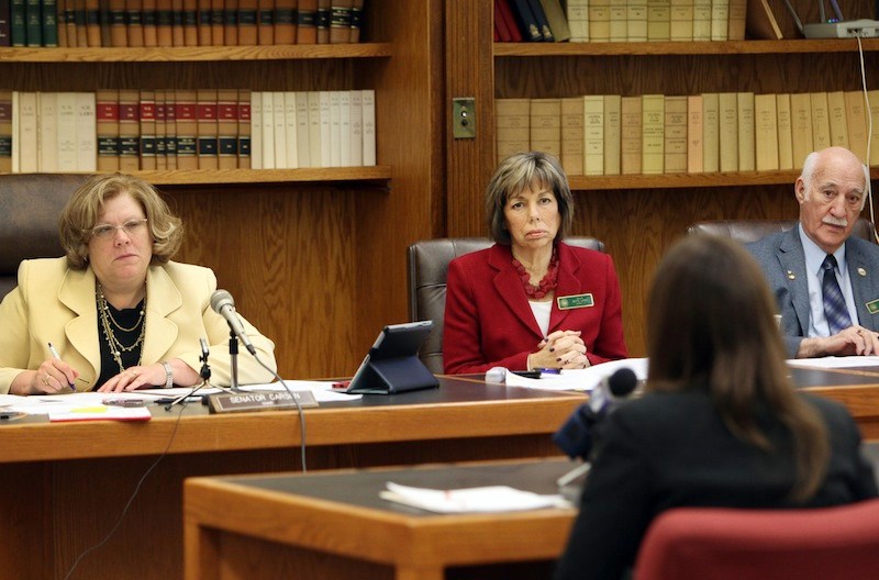 Members of the Senate Judiciary Committee, from left, Chair Sharon Carson, Bette Lasky, and Sam Cataldo listen to a rape victim during a hearing at the Statehouse in Concord, N.H. Tuesday Feb. 4, 2014. Lawmakers are considering a bill to terminate a parent's rights to a child if the child was conceived as a result of rape and the parent is convicted of the sexual assault.