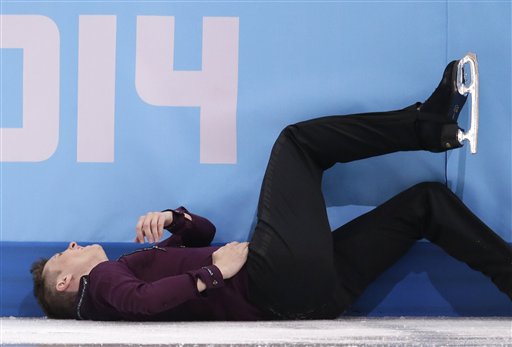 Jeremy Abbott of the United States lies on the ice after falling as he competes in the men's short program figure skating competition at the Iceberg Skating Palace during the 2014 Winter Olympics, Thursday, Feb. 13, 2014, in Sochi, Russia.