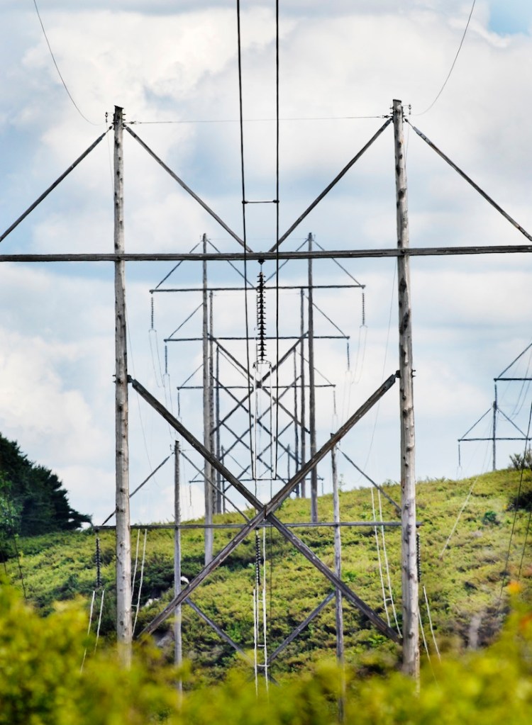 In this 2008 file photo, transmission lines cross Route 201 in Topsham. Two companies have become the first to publicly acknowledge a desire to compete for anticipated multimillion-dollar transmission line projects through Maine.