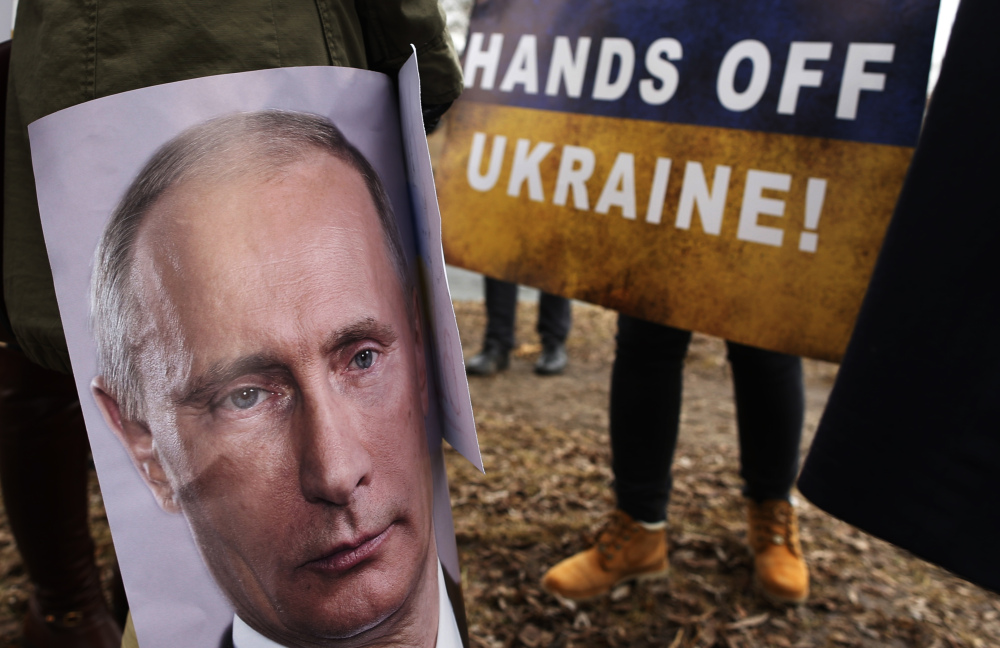 Demonstrators gather outside the Russian Embassy in Vilnius, Lithuania, to protest against Russian intervention in Ukraine.