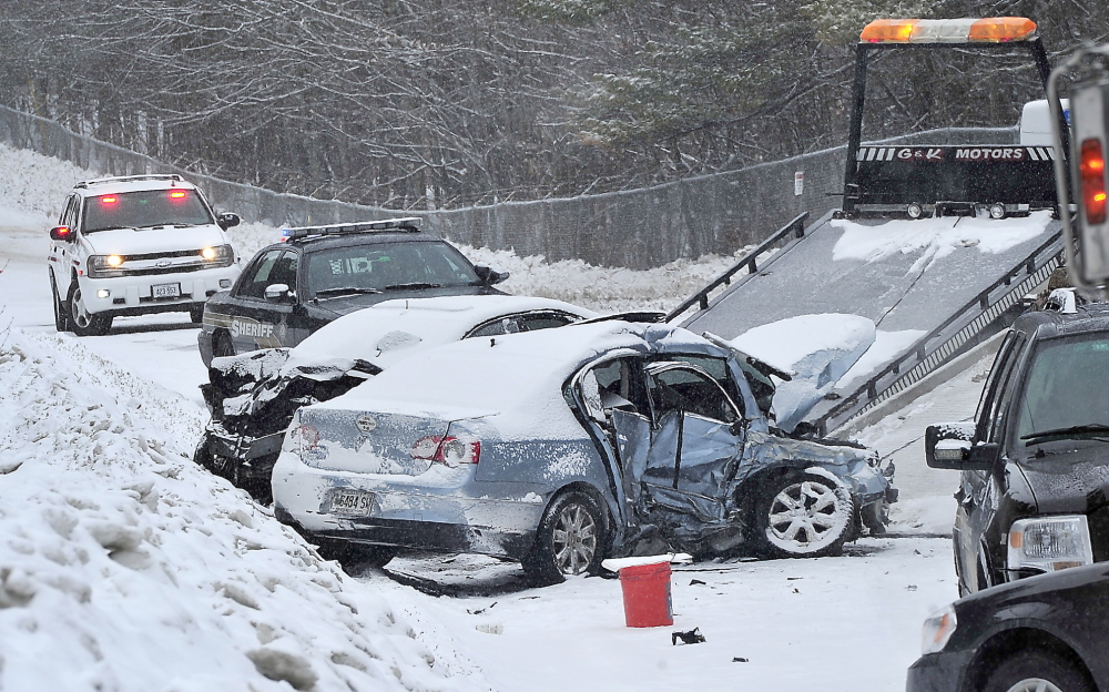 Two cars involved in a fatal crash on Chadbourne Road/Route 35 in Standish are readied for removal from the road. The 5 a.m. collision left a man dead and the surviving driver critically injured. Over the past 10 years, 184 crashes have occurred on this stretch of road.