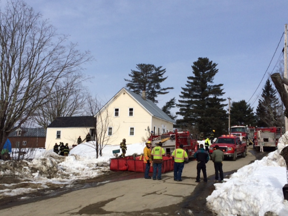 HOUSE DAMAGED: Firefighters work at the scene of a fire Wednesday morning at 17 School St. in Athens.