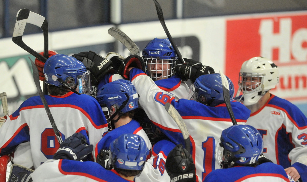 Staff photo by Michael G. Seamans Messalosnkee High School celebrates their 9-3 win over Presque Isle High School in the Eastern B Final game at Alfond Arena at the University of Maine in Orono on Tuesday.