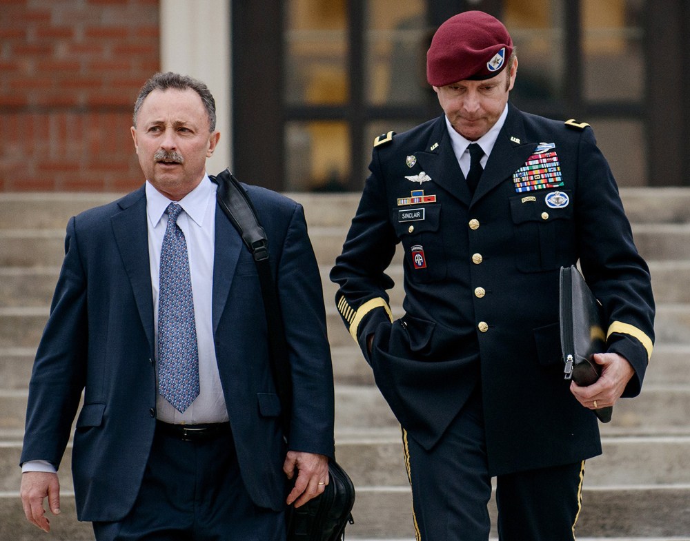 Brig. Gen. Jeffrey Sinclair, right, leaves the courthouse with his lawyer Richard Scheff last week in Fort Bragg, N.C. A military judge declined Monday to dismiss sexual assault charges against Sinclair after reviewing what he said was evidence that political considerations influenced the military’s handling of the case.