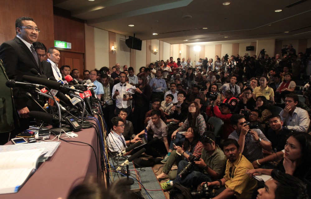 Malaysian acting Transport Minister Hishammuddin Hussein, left, answers a question during a news conference at a hotel in Sepang, Malaysia, on Wednesday.
