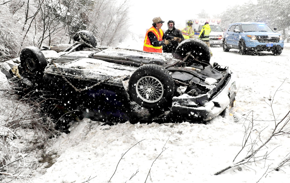 YET ANOTHER ACCIDENT: This car rolled over Wednesday alongside the southbound lanes of I-95 in Waterville. Several other accidents occurred between mile 129 and 131, keeping wreckers and police busy.