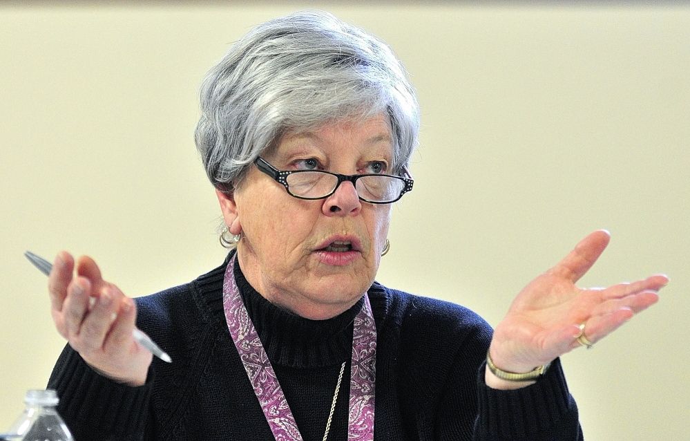 Her explanation: Jane Hubert, chairwoman of the Pittston Board of Selectmen, answers a question from a resident Saturday during debate at the Town Meeting in the Pittston Consolidated School.