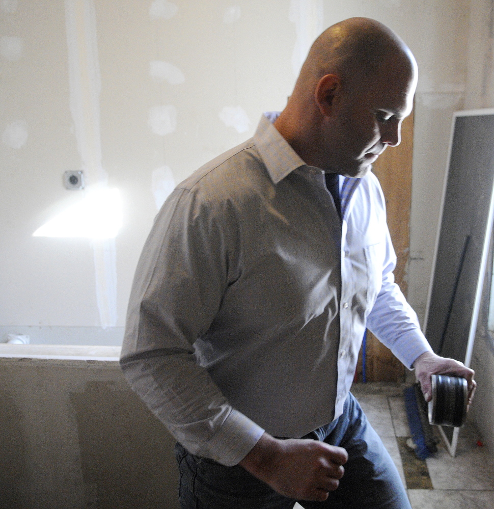 Gas detection: Jason Mills, of Maine Professional Inspections, collects a radon test Feb. 12 at an apartment building in Augusta. State law required all residential rental properties to be tested by March 1.