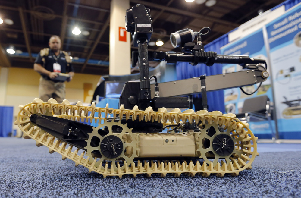 Steven Roberson, of QinetiQ, demonstrates a robotic system at the Border Security Expo in Phoenix.