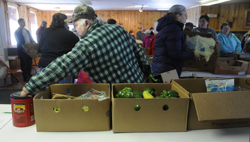CLOSING: Douglas Mason Sr. of Augusta makes a contribution Tuesday at the East Winthrop Baptist Church Food Ministry before collecting fruit, vegetables and other perishable items that were donated by Hannaford. Hannaford will no longer give to food pantries unaffiliated with Good Shepherd Food bank. The move will mean hundreds of families, including more than 100 who depend on the East Winthrop Baptist Church Food Ministry, will have to find other sources of food.