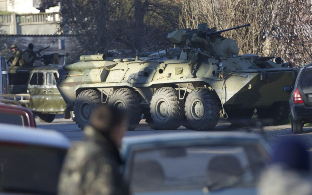 A Russian APC breaks into the fence of the Belbek airbase gate after Russian troops took control, outside Sevastopol, Crimea, on Saturday. Russian forces used at least four armored vehicles to break into an air base here, seizing control of one of the last Ukrainian military outposts in Crimea.