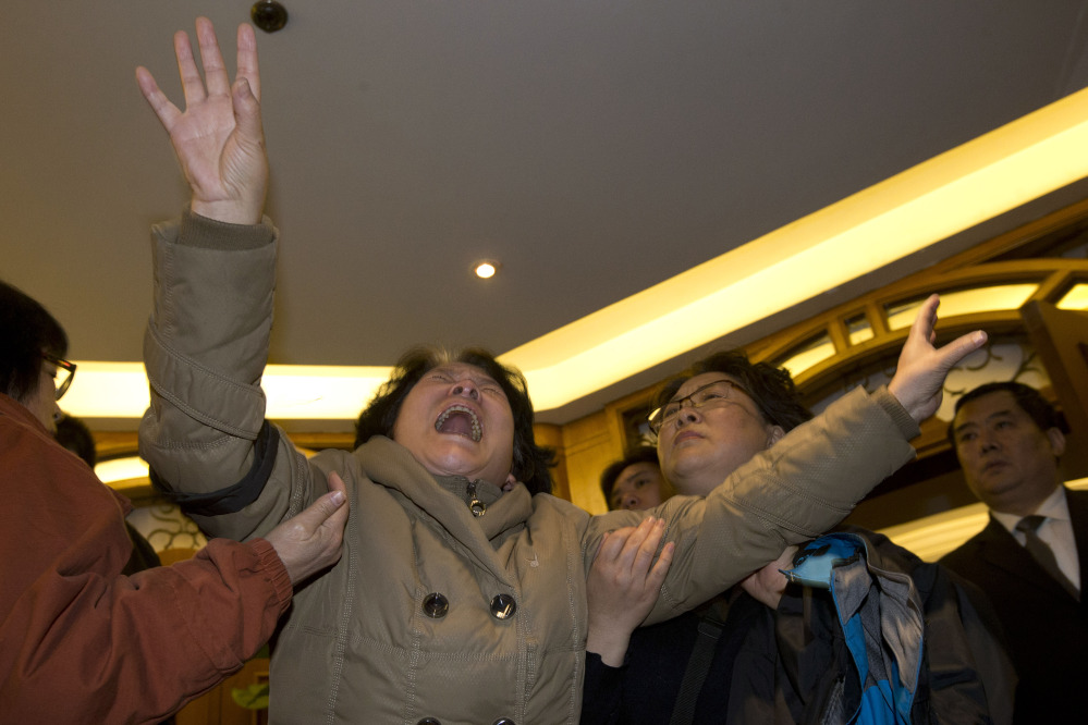 A relative of one of the Chinese passengers aboard the Malaysia Airlines jet, MH370, grieves after being told of the latest news in Beijing, China, Monday.