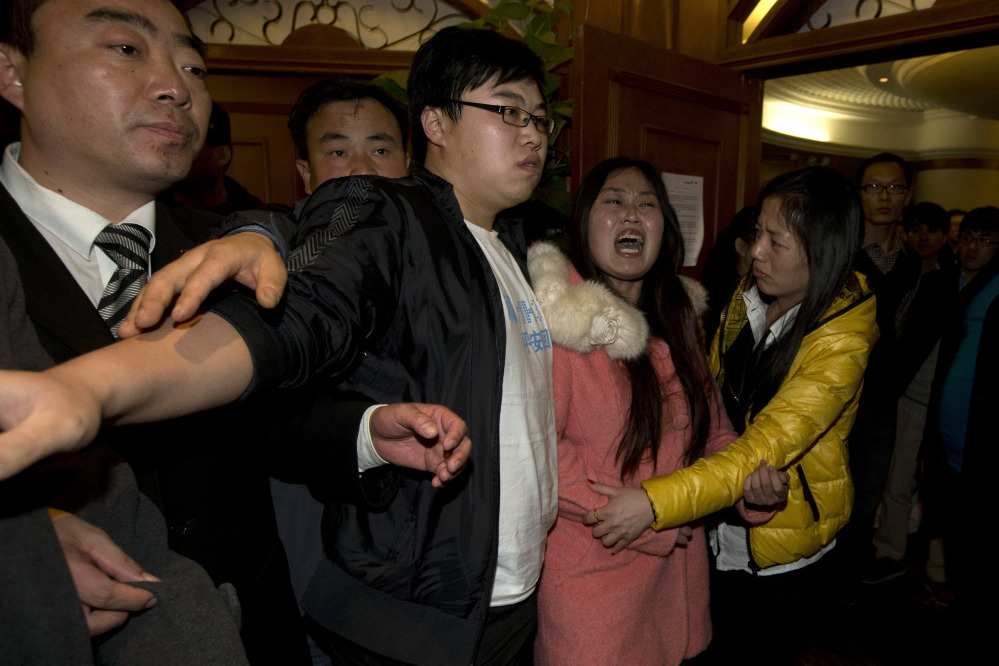 Relatives of Chinese passengers aboard the Malaysia Airlines, MH370 grieve after being told of the latest news in Beijing, China, Monday.